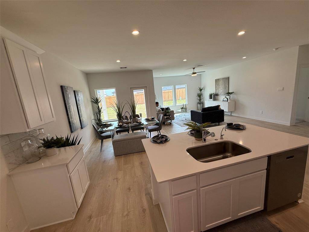 Stunning granite countertops and sleek stainless steel appliances, including a refrigerator.