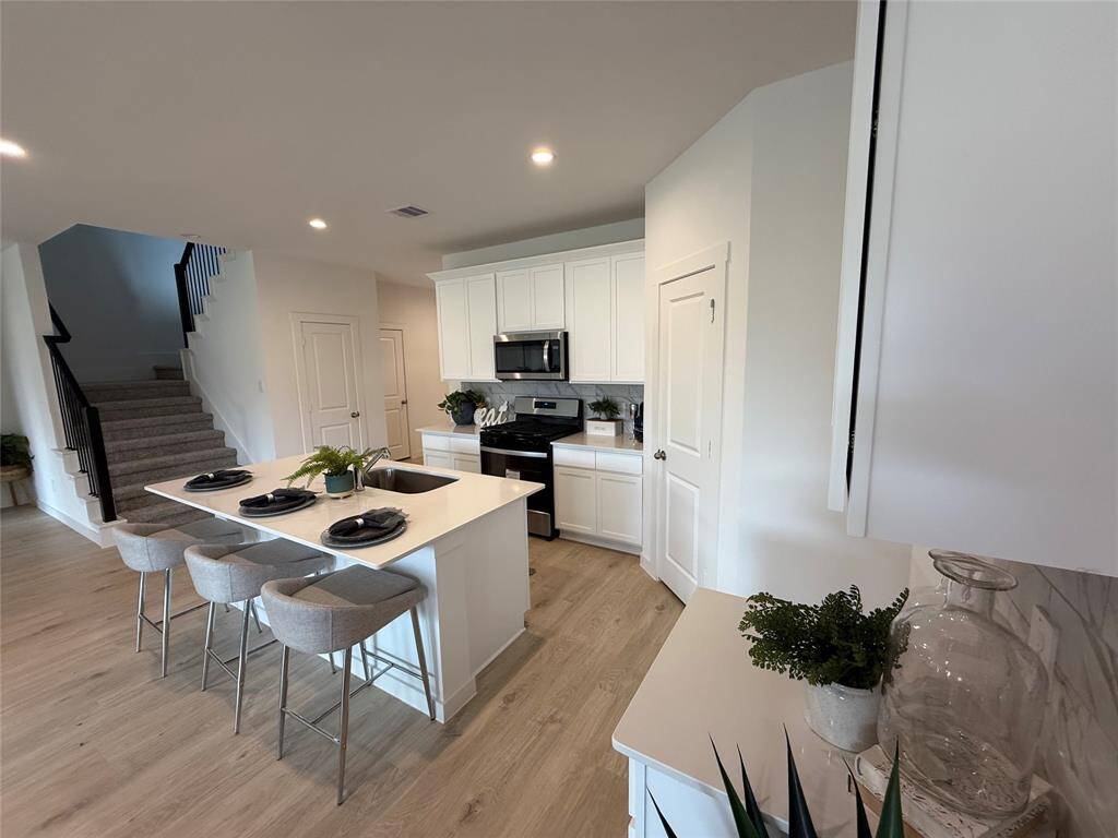 Modern, open-concept living, dining, and kitchen area for seamless entertaining.