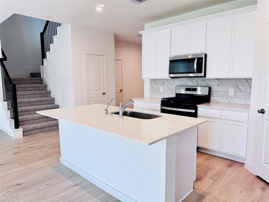 Elegant granite countertops paired with sleek stainless steel appliances.