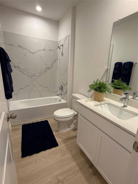 Stunning granite countertops and sleek stainless steel appliances, including a refrigerator.