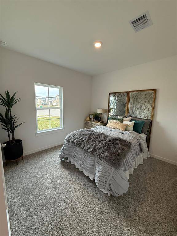 Luxurious granite countertops and sleek stainless steel appliances, with a refrigerator included.