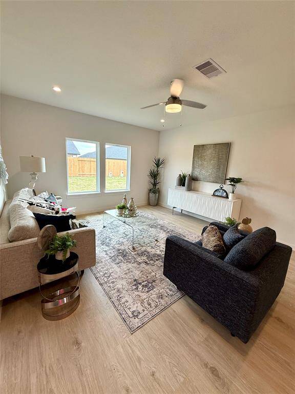 Spacious master bedroom with plush carpeting, modern decor, and ample natural light. Perfect for relaxation and comfort.