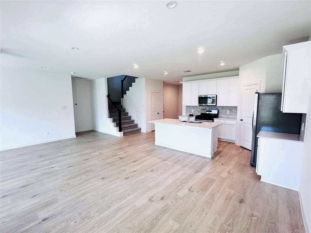 Experience seamless living in this spacious open-concept area, perfect for entertaining and family gatherings.
