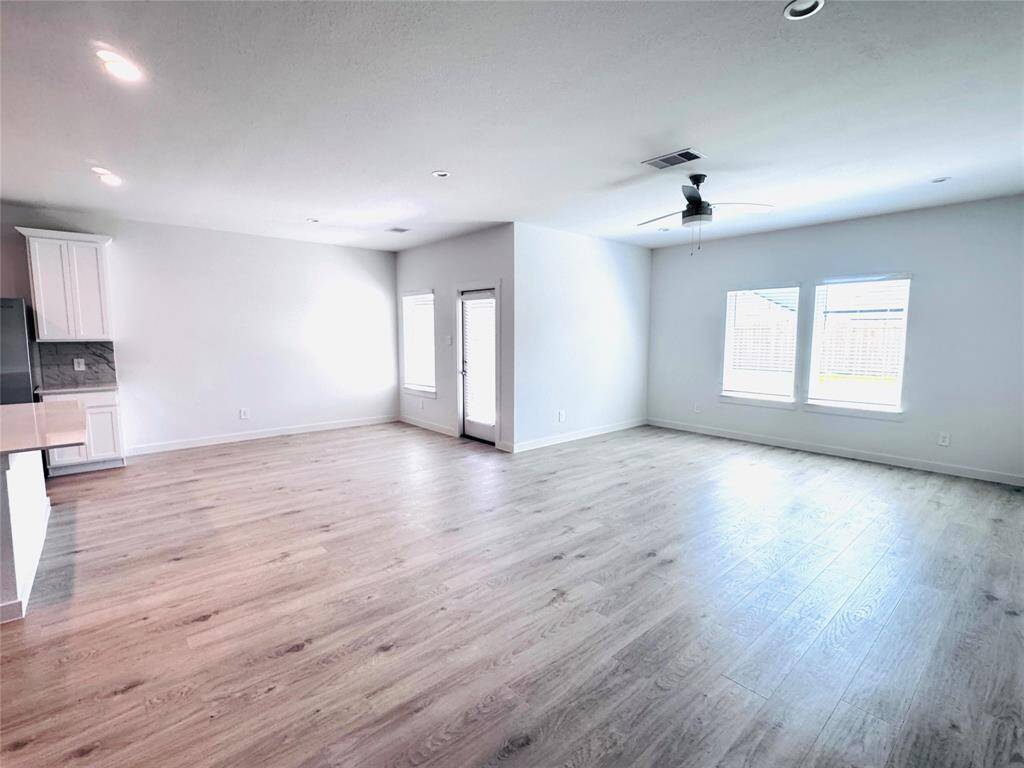 Spacious open-concept living area seamlessly connecting the kitchen and dining spaces.