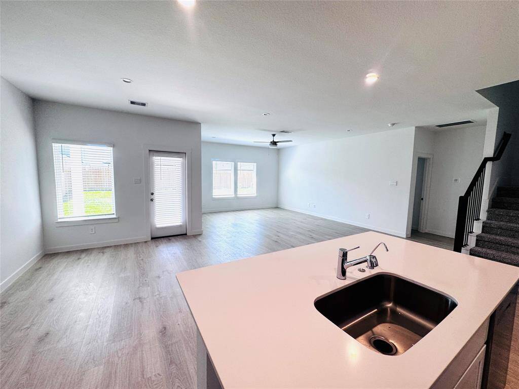 Experience seamless living in this open-concept space, featuring large windows that frame views of the inviting covered patio.