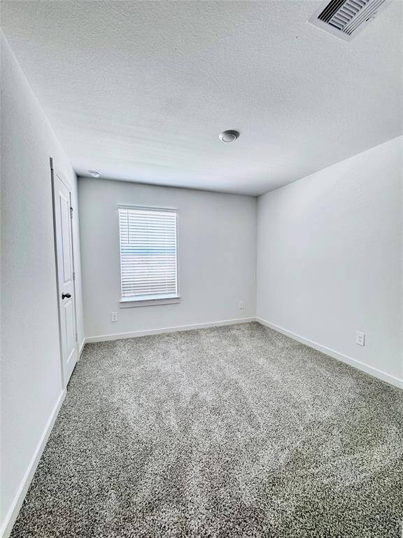 Beyond the kitchen and dining area, discover the inviting master bedroom.