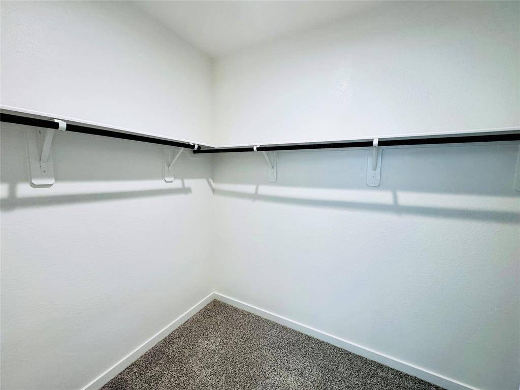 Spacious walk-in closet offering ample storage and organization.