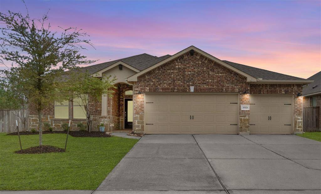Stunning front facade showcased in virtual twilight. The south-facing entrance ensures beautiful sunset views to the left.
