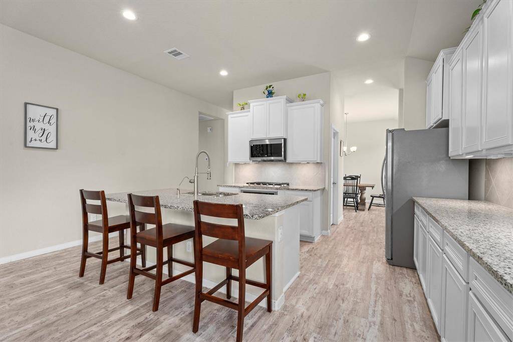 Open-concept kitchen seamlessly connects the living and dining areas, creating a spacious and inviting atmosphere.