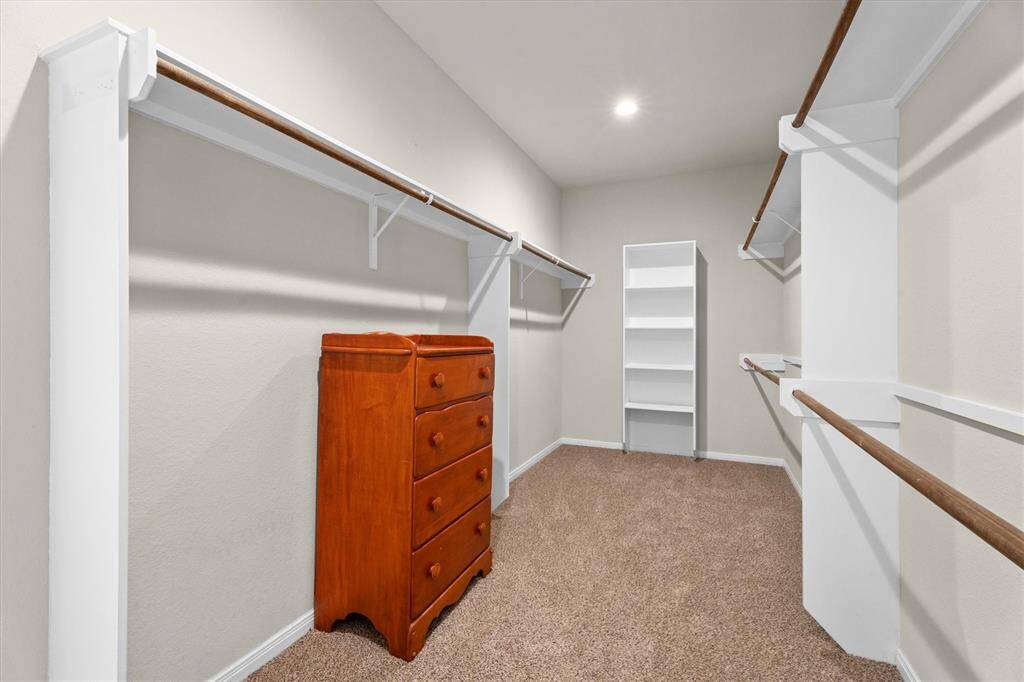 Discover the expansive 17.5-foot deep walk-in closet, conveniently located off the primary en-suite bathroom.