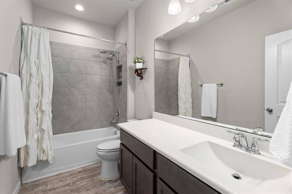 Conveniently located between the third and fourth bedrooms, this bathroom offers easy access and functionality.