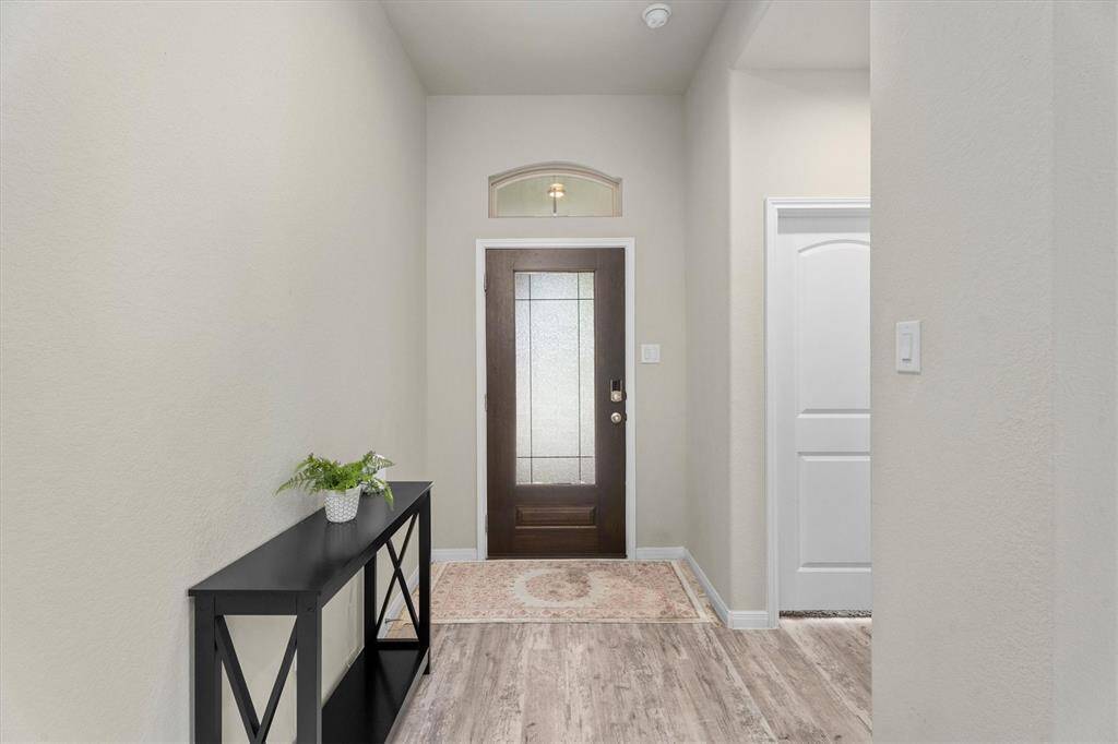 A welcoming entryway features a convenient closet and direct access to the guest suite.