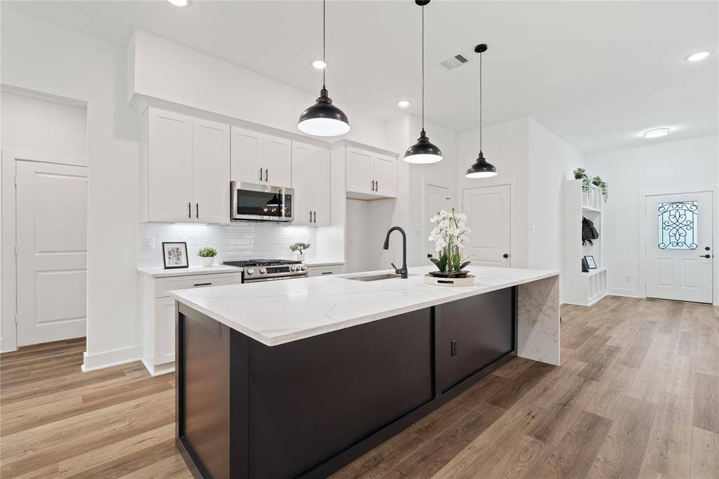 The expansive kitchen features a large island, offering plenty of room for seating and perfect for both meal prep and casual gatherings.