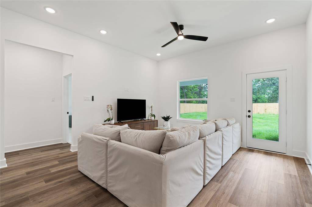 Bright and spacious, this living room features clean white walls and recessed lighting that enhance the airy atmosphere.