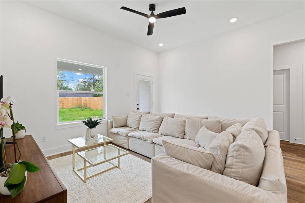 The large windows bring in ample natural light, offering a serene view of the backyard.