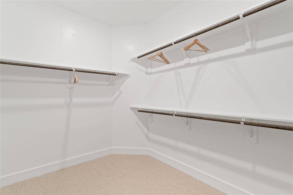 The clean lines of the shelving and hanging rods create a sleek, functional space.