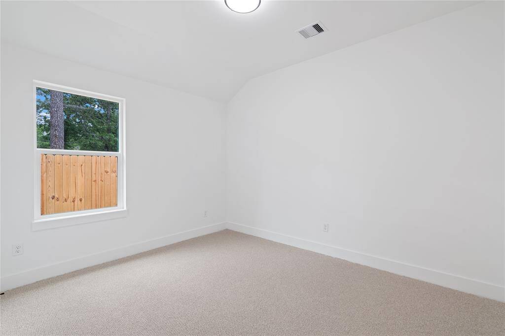 The third bedroom is also bright and airy with a large window providing natural light.