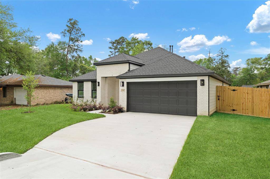 The extended driveway offers plenty of space for parking and enhances the home’s inviting curb appeal.