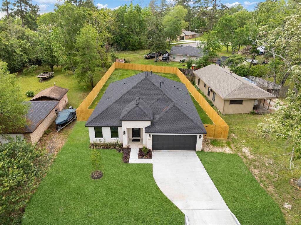 From this bird's-eye perspective, the home’s charming exterior and well-manicured landscaping come into full view, showcasing the expansive front and backyard areas.
