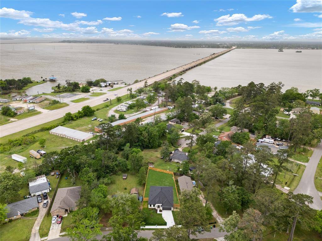 The surrounding greenery and mature trees add to the sense of tranquility, while nearby homes are positioned far enough to offer a peaceful, private setting.