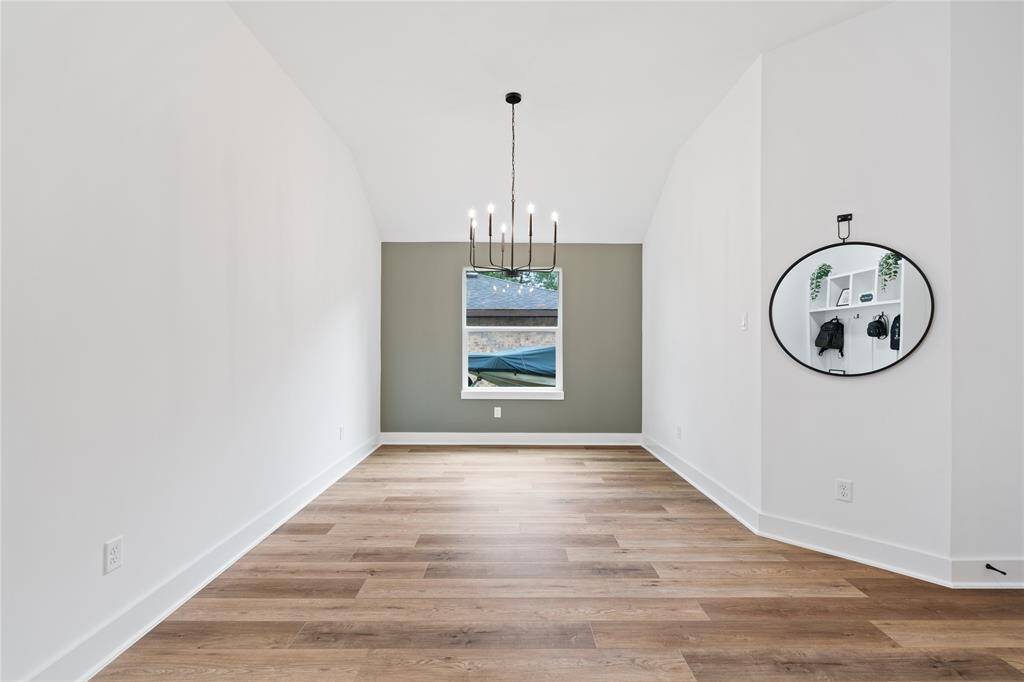 A rich accent wall in a beautiful color adds sophistication, while the luxury vinyl plank floors provide warmth and texture.