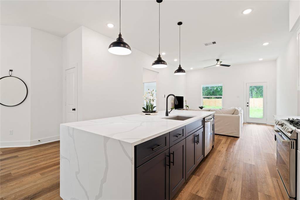 An inviting open-concept kitchen seamlessly transitions into the living room, creating an ideal space for entertaining.