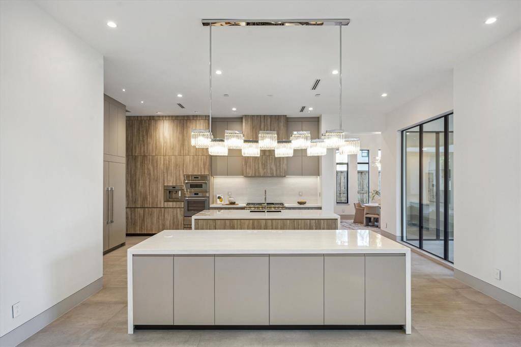 Double island kitchen with seating and storage.  Porcelain countertops with waterfall detail.  Large walk in pantry.