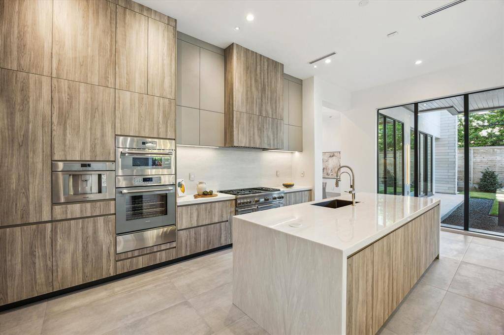 Stainless Thermador appliances. Porcelanosa cabinets and countertops made in Spain
