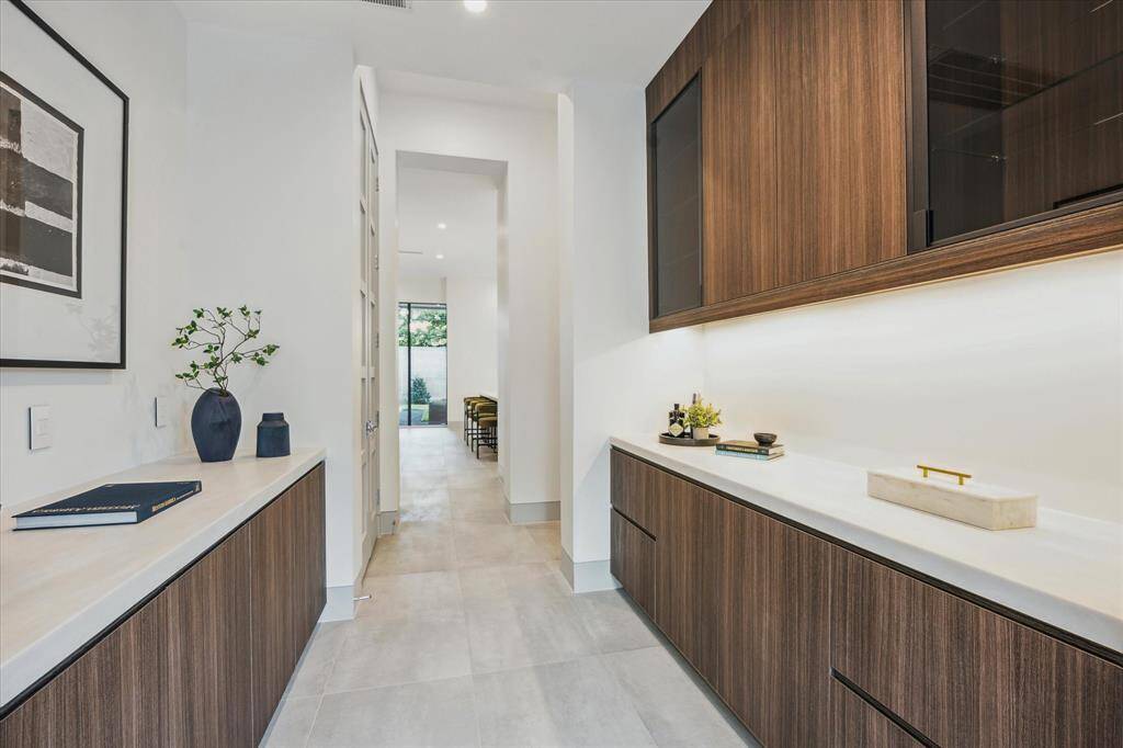 Butler's pantry with cabinet and drawer storage.  Access to dining room and kitchen