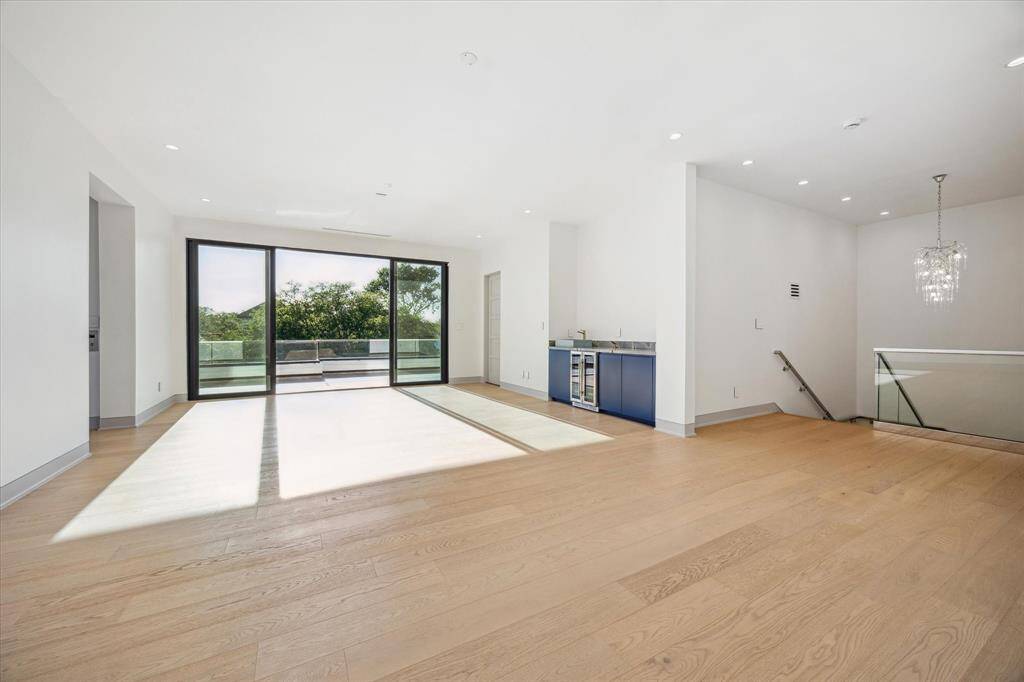 Third floor game room with wet bar, powder bath, and glass sliding doors to large terrace