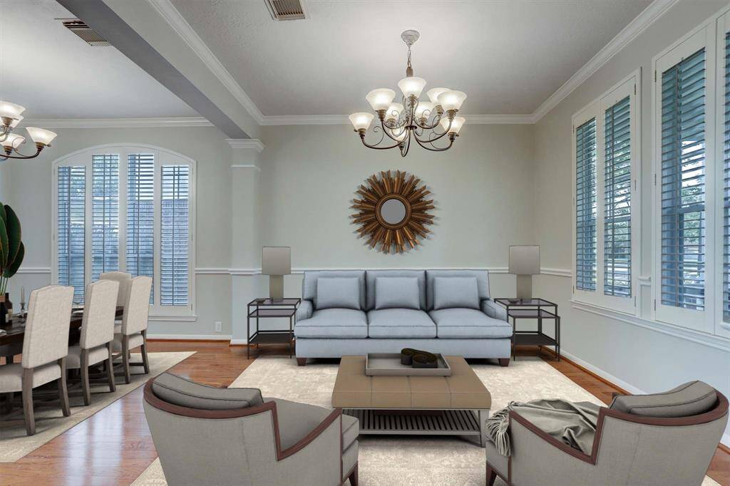 This spacious room features elegant hardwood flooring, large windows with plantation shutters, and stylish light fixtures, perfect for a dining or living area.