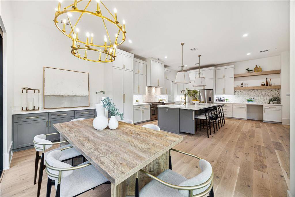 Perfectly positioned for effortless entertaining, the dining room flows seamlessly into the kitchen and features a stylish serving counter along one wall—ideal for buffet-style meals, beverage service, or additional display space.