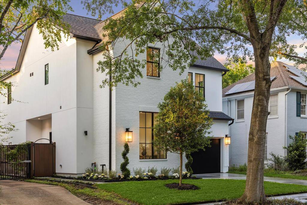 Thoughtfully designed landscaping adds a lush, welcoming touch, enhancing the home’s modern aesthetic with vibrant greenery and manicured detail. A timeless and luxurious first impression that invites you in.