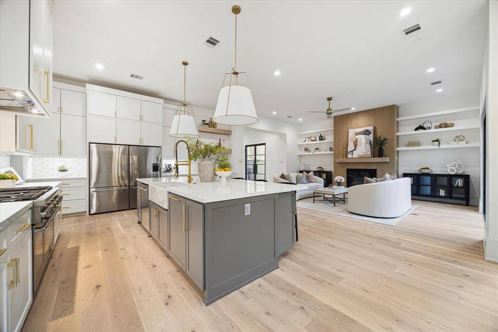 The spacious layout ensures a natural flow between spaces, allowing the chef to stay engaged with family and guests. With its high-end finishes, large island, and abundant counter space, the kitchen effortlessly blends with the family room and adjacent areas, creating an ideal environment for gatherings and shared moments.