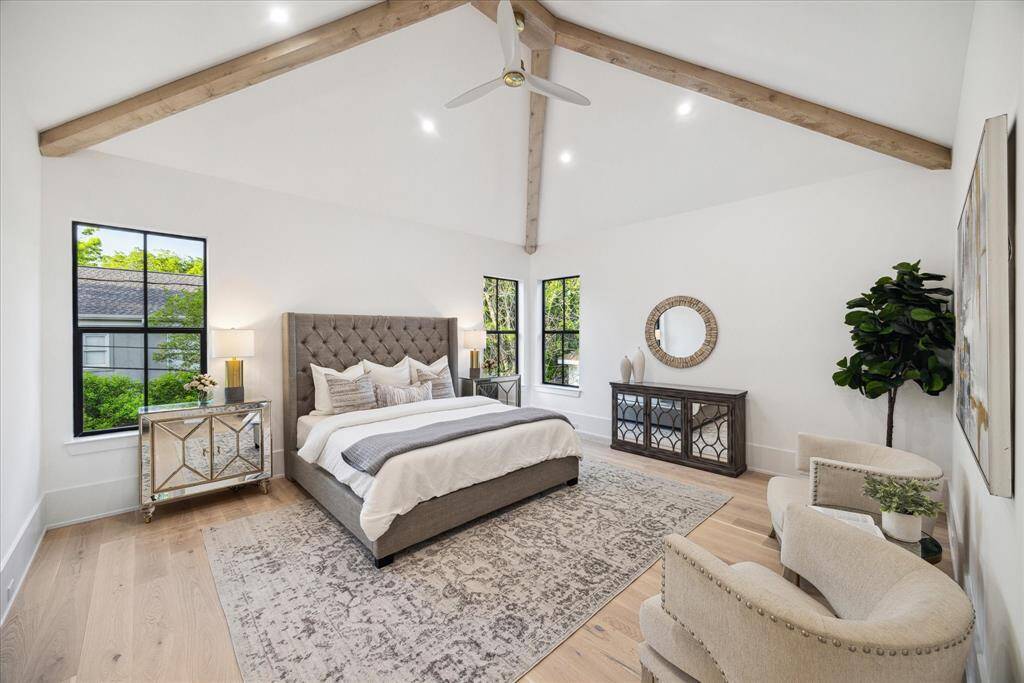 [PRIMARY BEDROOM] Retreat to a stunning primary suite designed with both luxury and comfort in mind. Vaulted ceilings with a decorative beam create an airy, architectural elegance, while oversized windows flood the room with natural light. A true sanctuary in the heart of this beautiful home.