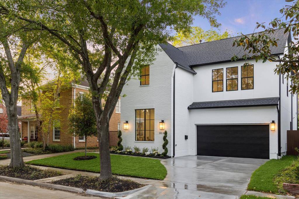 Expansive windows allow natural light to pour into the home while adding a bold architectural statement to the facade. A perfect balance of elegance and contemporary charm, this exterior sets the tone for the luxury that awaits inside.