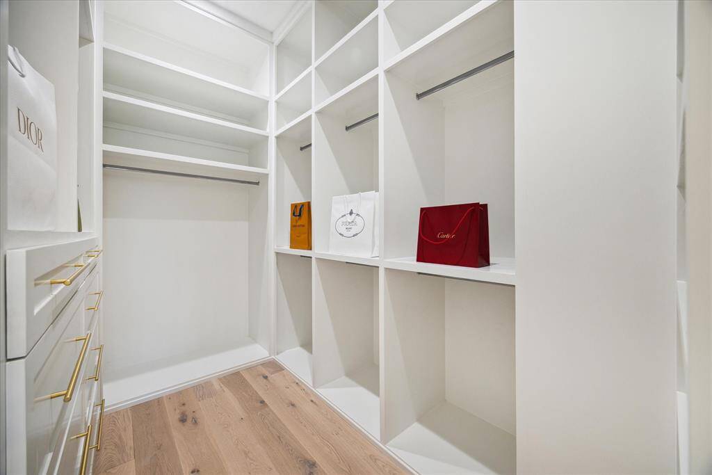 [PRIMARY CLOSET] The primary closet offers the ultimate in organization and style, with custom built-ins, abundant hanging space, and thoughtfully designed shelving to accommodate every wardrobe need.
