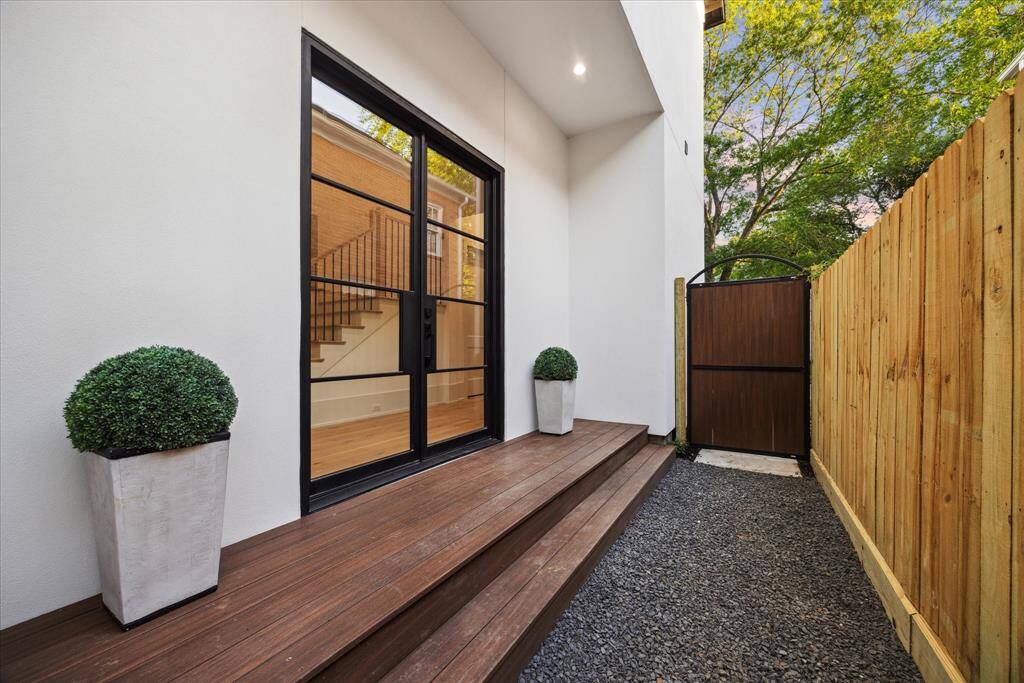 [ENTRANCE] A rare architectural gem, this newly built home features a unique side entrance that sets it apart from the rest. Framed by sleek, oversized glass doors, this distinctive entryway floods the interior with natural light while creating a striking, modern welcome.