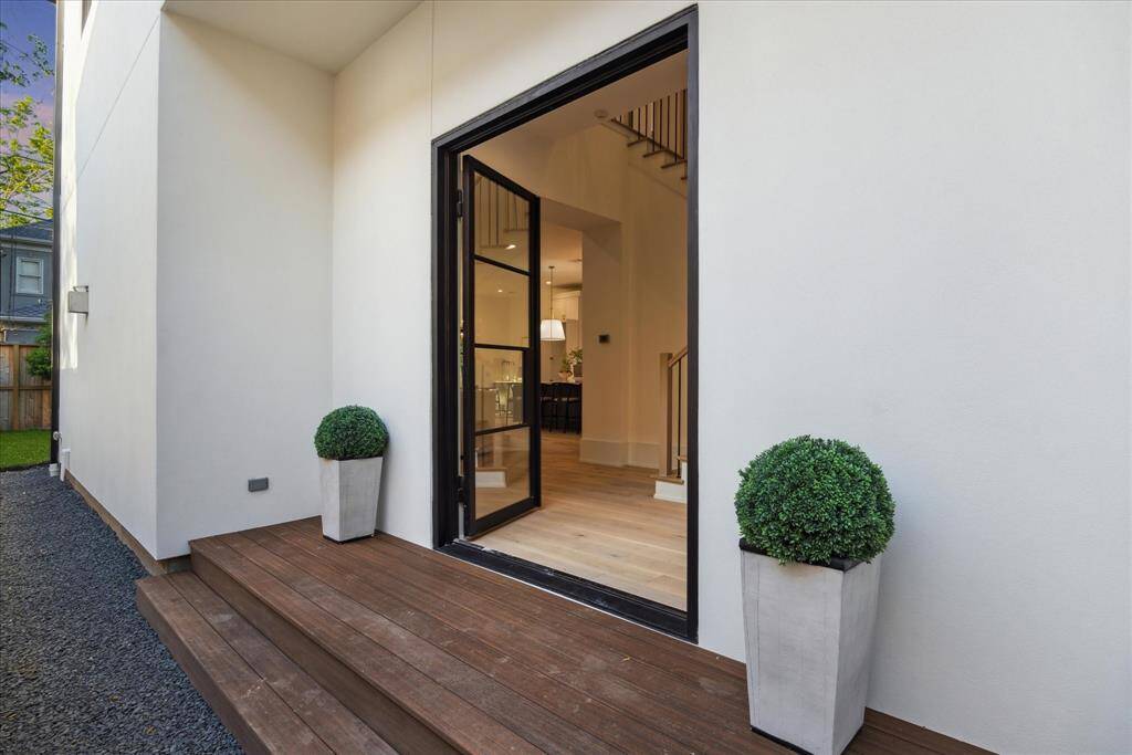 Both functional and visually stunning, the side entrance offers enhanced privacy and a seamless connection to the outdoor living spaces—perfectly blending form and function.
