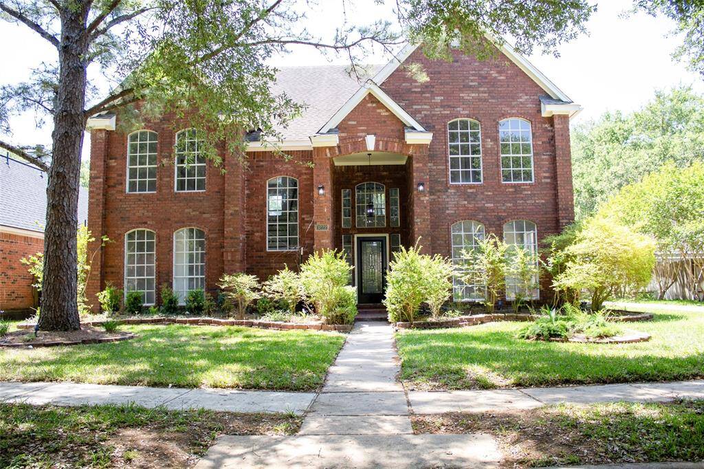 Charming curb appeal with mature landscaping, and a welcoming entrance