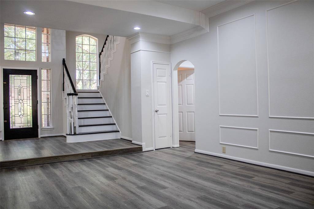 Bright and inviting living area with new flooring, fresh paint, and upgraded recessed lighting throughout