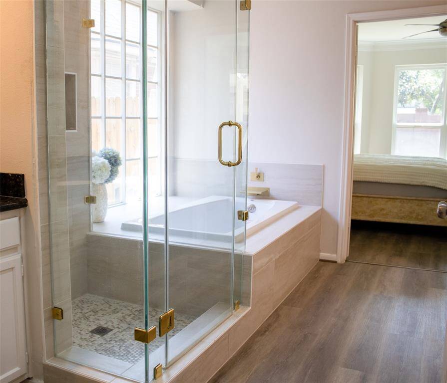 Newly renovated spa-like primary bath with Jacuzzi tub, walk-in shower