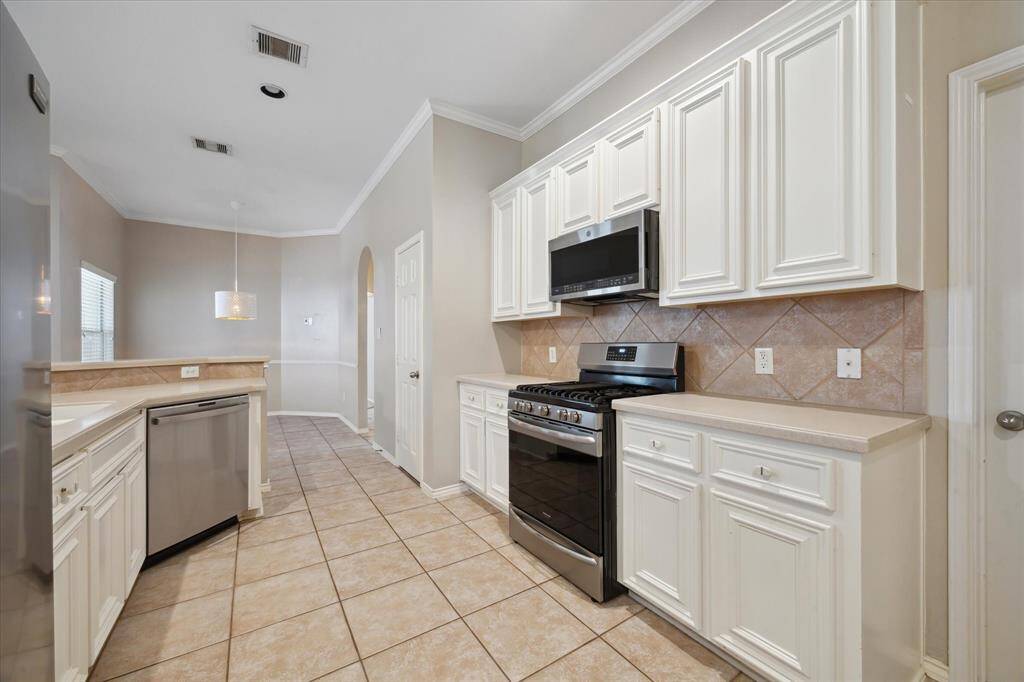 Another view of the kitchen, in home utility room and garage access to the right