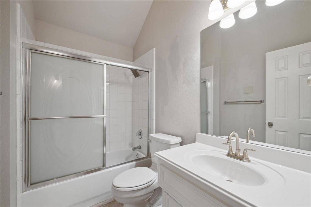 Second full bathroom with tub/shower combo and sliding glass doors