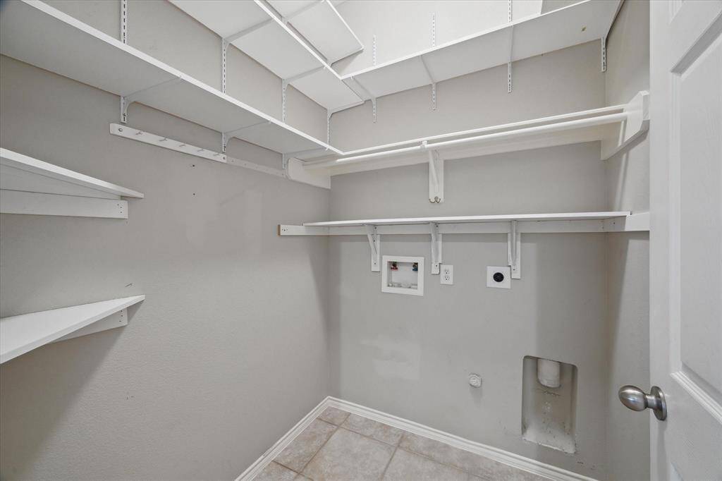 Utility room in house with shelving