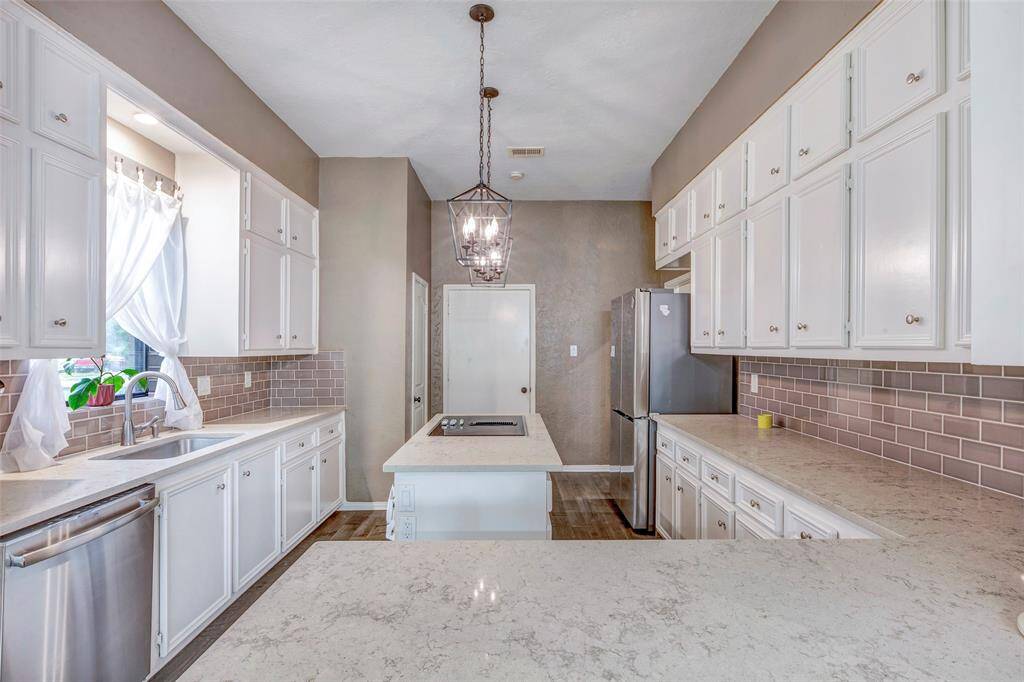 Beautiful! Pantry tucked in just before entrance to garage. Beautiful counter tops replaced in 2018.