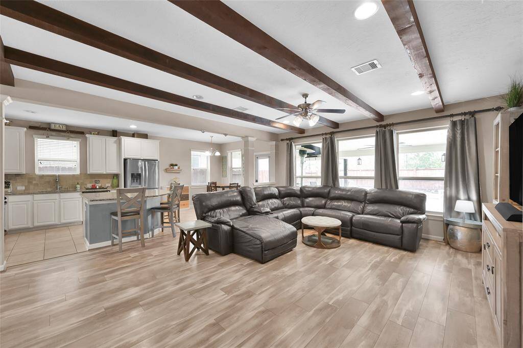 This open concept home is perfect for entertaining large groups and views of the covered patio and pool areas.