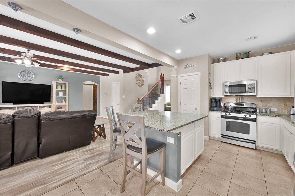 The kitchen has stainless steel appliances with a gas range.  The cabinets were painted white in 2017 and the counter tops are a light, neutral granite.