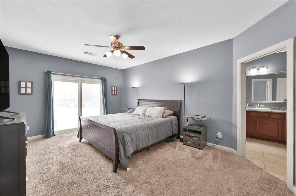 Located on the first floor is the primary suite with sliding glass doors for an easy, private access to the backyard and swimming pool/spa!