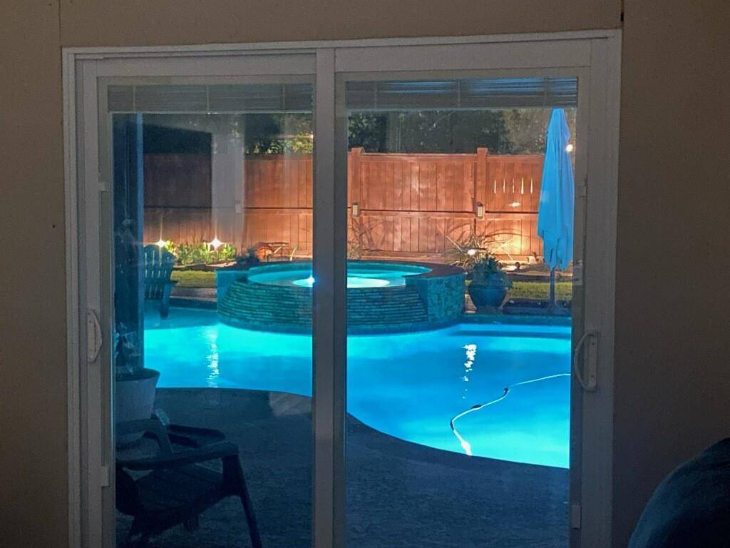 Check out this nighttime view of the backyard pool and spa from the primary suite!